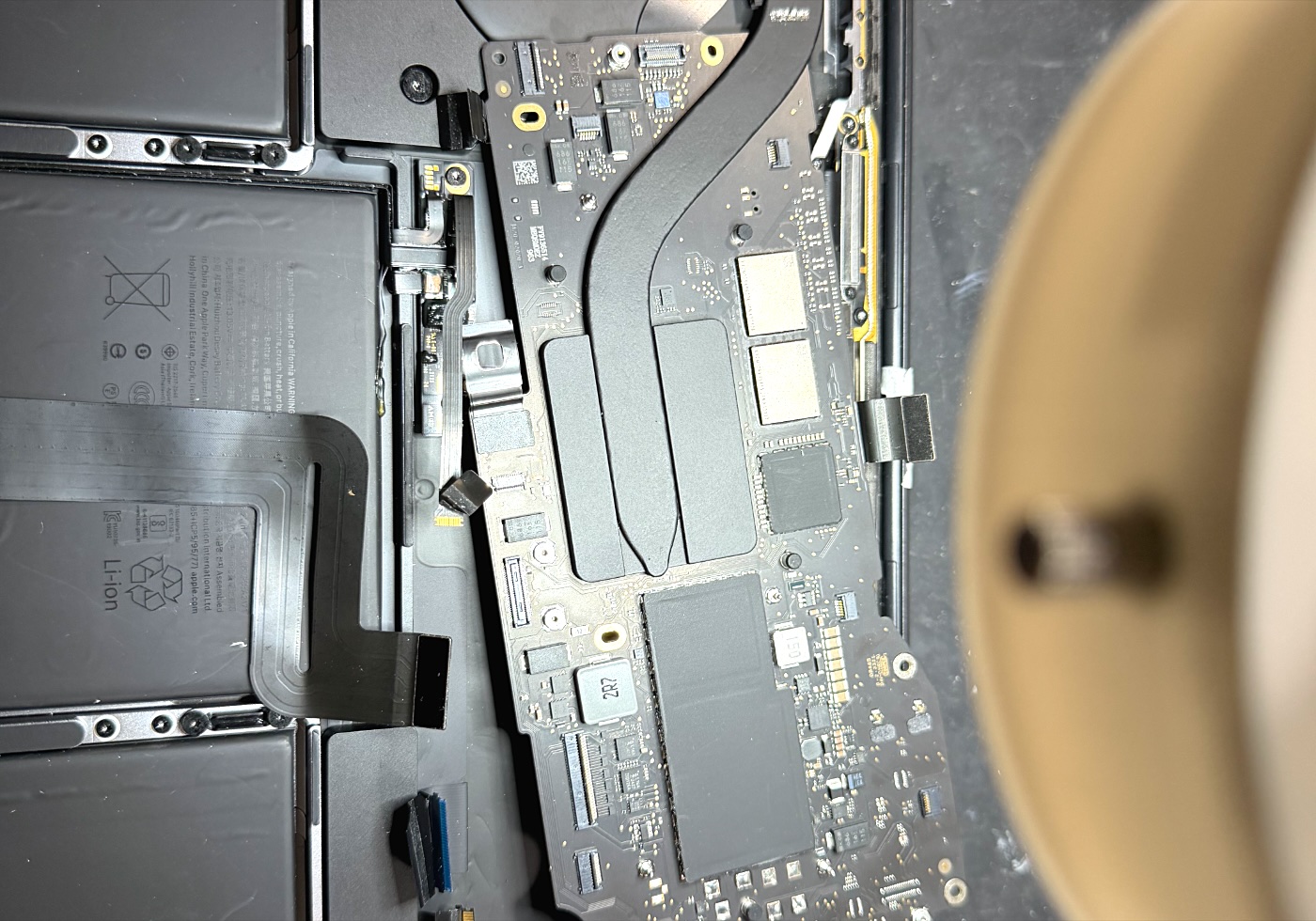 MacBook opened under microscope for logic board repair